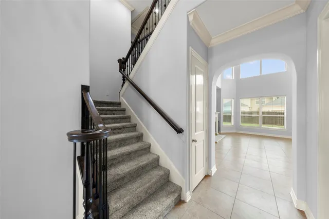 a view of entryway with wooden floor and stairs