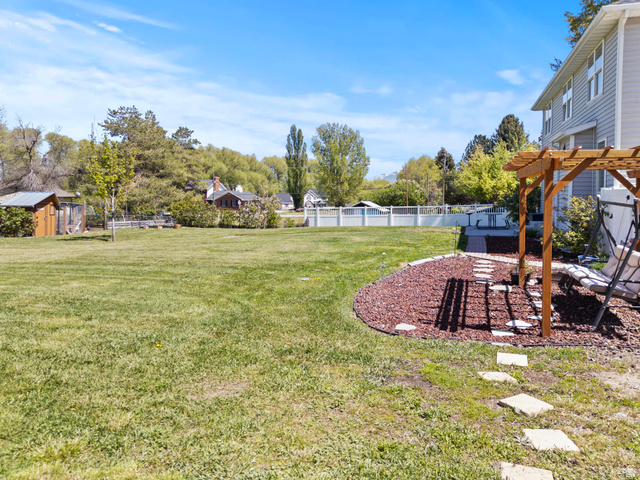 75 East 200 North Mendon, UT 84325 - Photo 22 of 36 Fenced yard featuring a pergola and a patio area