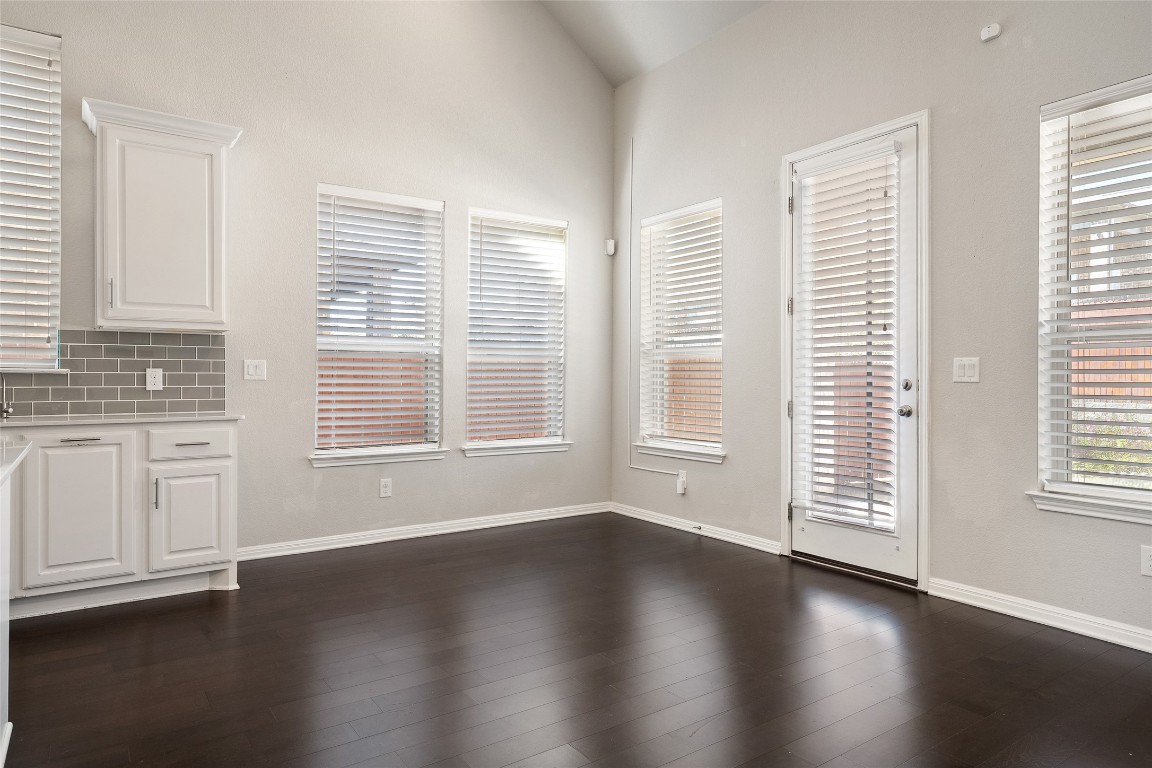 2909 Zelma Drive Cedar Park, TX 78613 - Photo 14 of 40 Unfurnished dining area with vaulted ceiling and dark wood-type flooring
