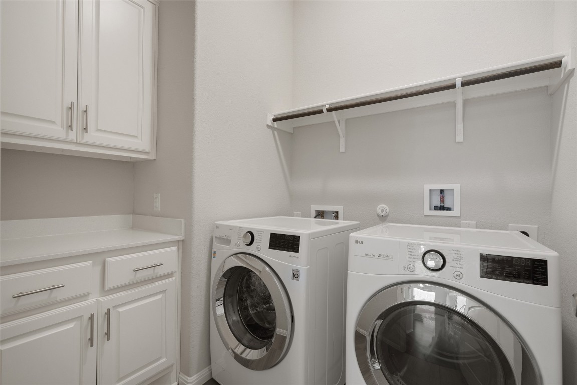 2909 Zelma Drive Cedar Park, TX 78613 - Photo 25 of 40 Laundry room featuring cabinet space and washer and clothes dryer