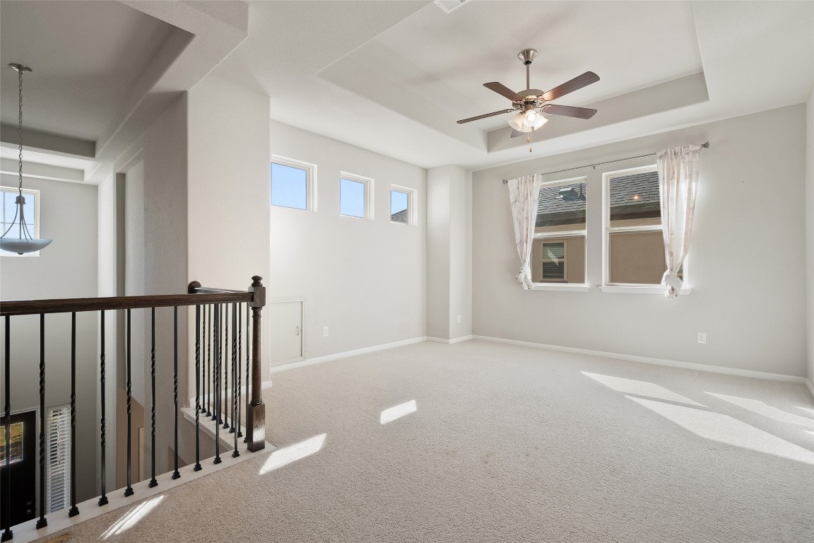 2909 Zelma Drive Cedar Park, TX 78613 - Photo 28 of 40 Unfurnished room featuring a tray ceiling, carpet floors, and a ceiling fan