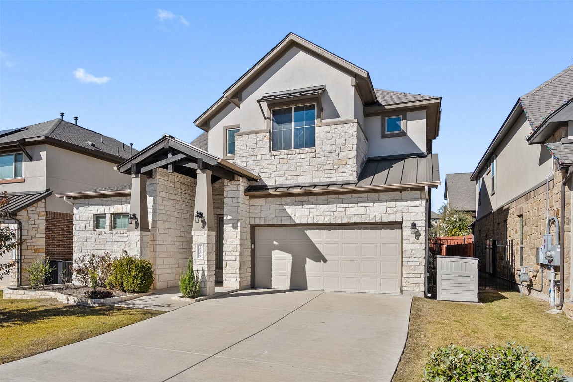 2909 Zelma Drive Cedar Park, TX 78613 - Photo 3 of 40 View of front of property with stone siding, a standing seam roof, a metal roof, an attached garage, and stucco siding