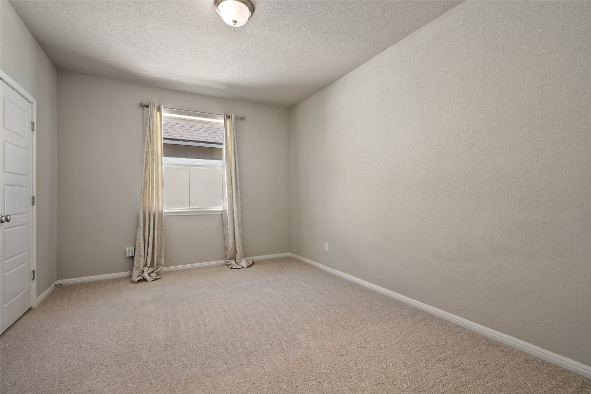 2909 Zelma Drive Cedar Park, TX 78613 - Photo 31 of 40 Empty room featuring light carpet and a textured ceiling