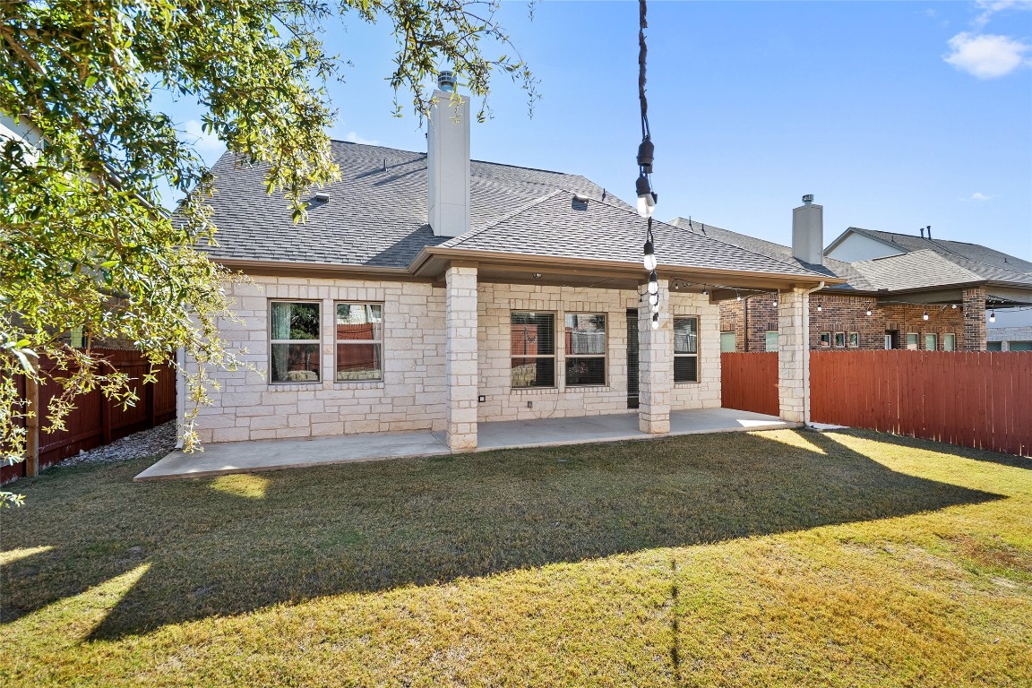2909 Zelma Drive Cedar Park, TX 78613 - Photo 36 of 40 Rear view of house with a patio area, a chimney, roof with shingles, and a fenced backyard