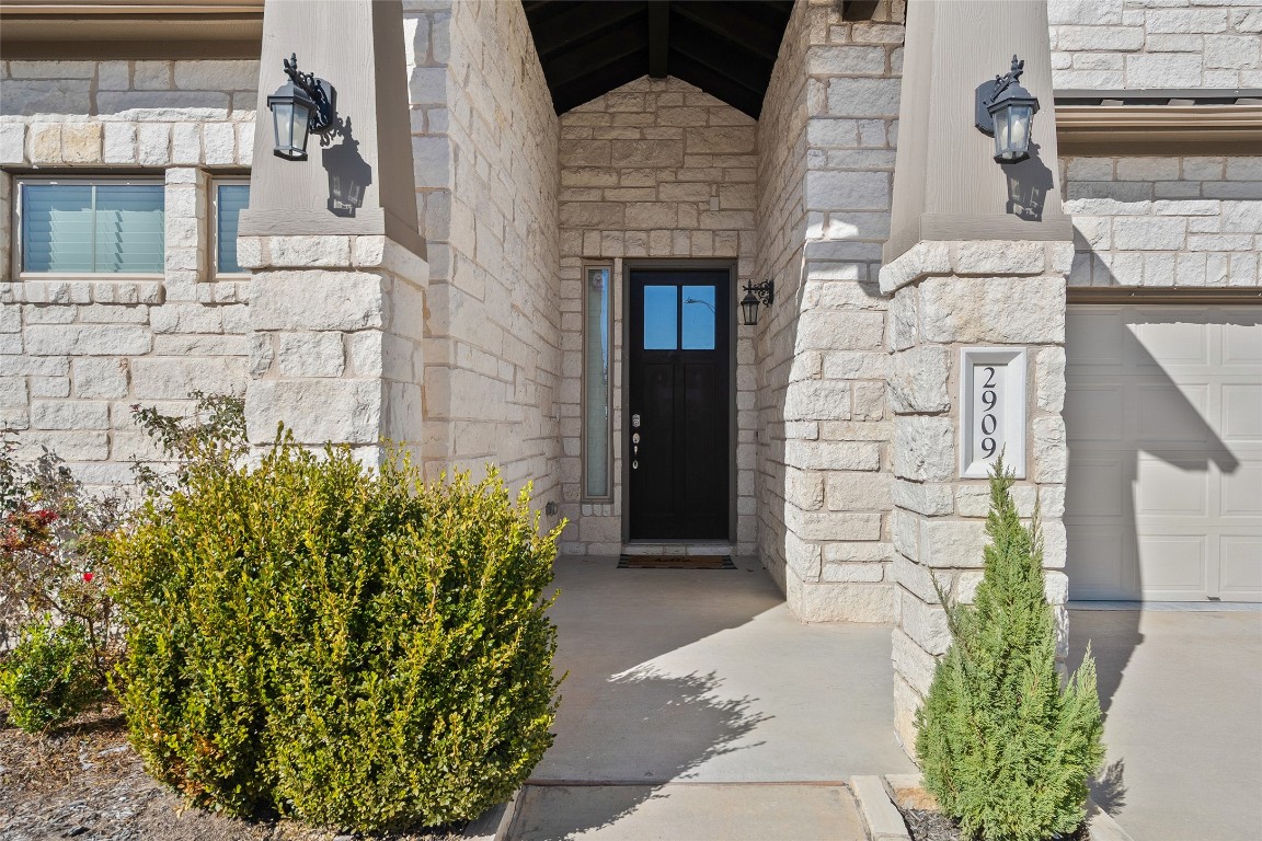 2909 Zelma Drive Cedar Park, TX 78613 - Photo 4 of 40 Property entrance with stone siding and a garage