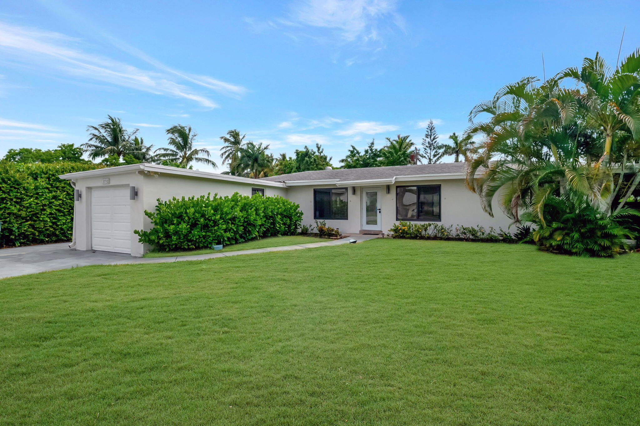 a front view of a house with a garden