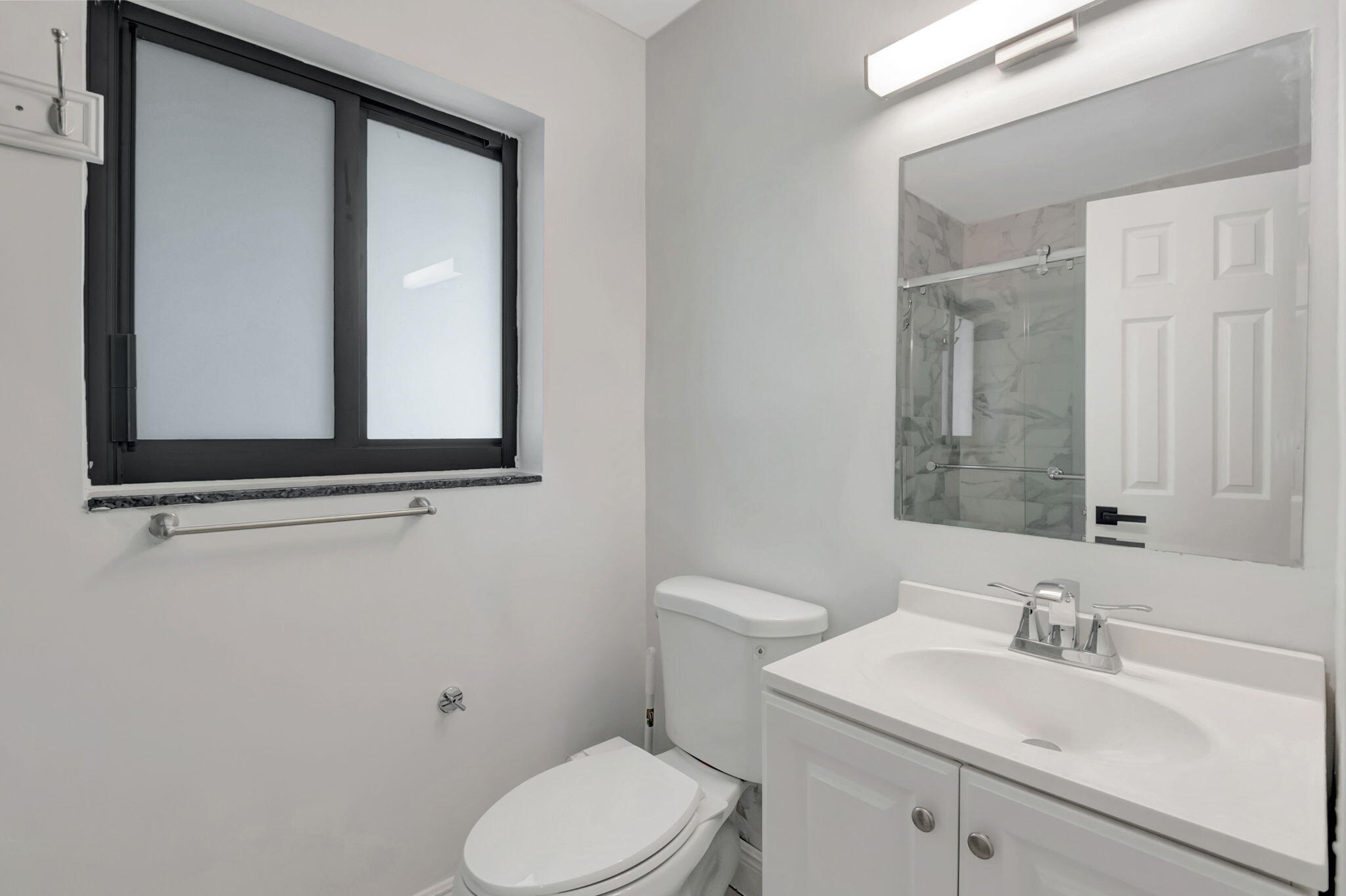 3550 Northeast 4th Avenue Boca Raton, FL 33431 - Photo 13 of 26 a bathroom with a toilet sink and mirror