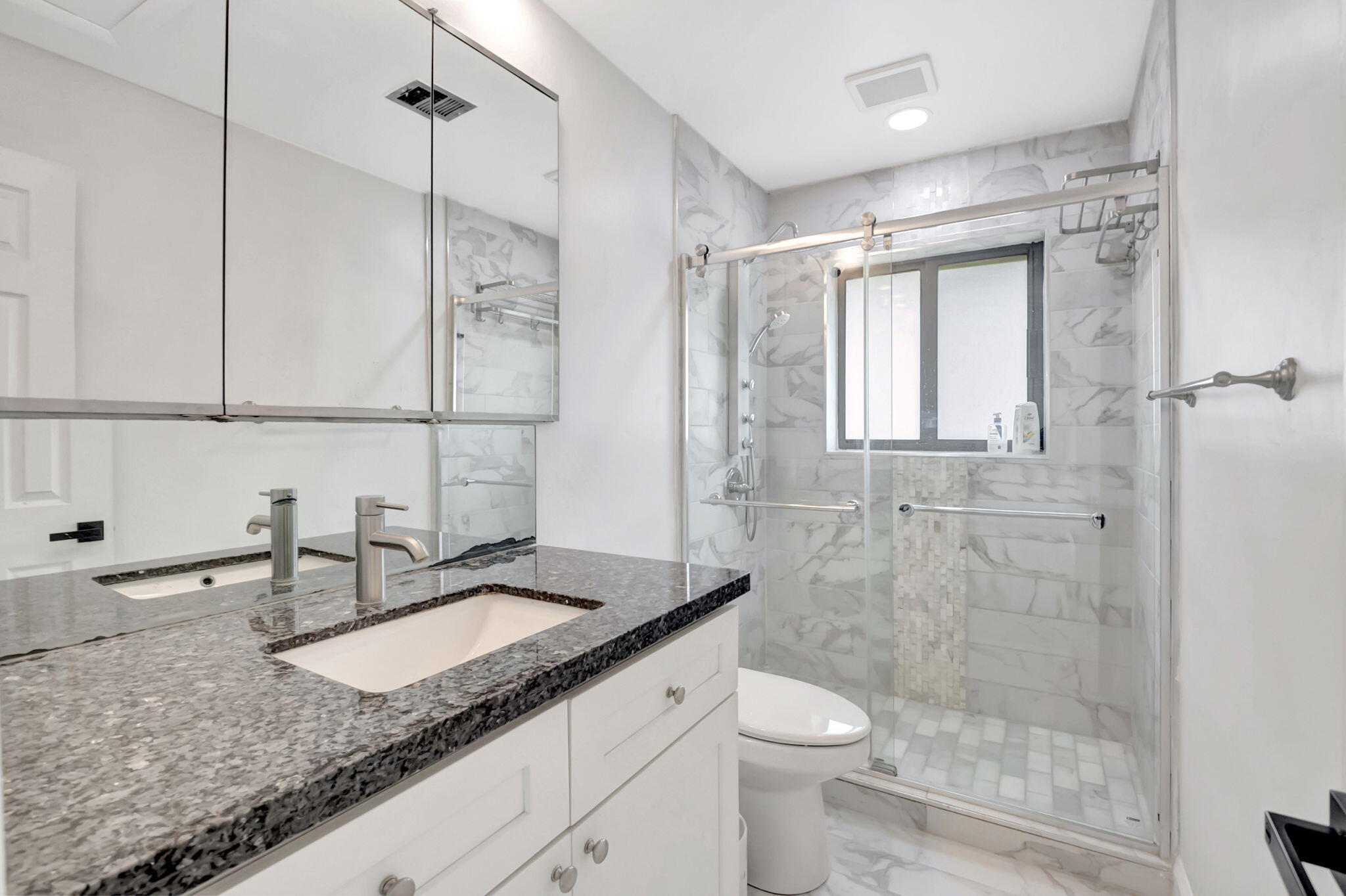 3550 Northeast 4th Avenue Boca Raton, FL 33431 - Photo 17 of 26 a bathroom with a granite countertop sink a toilet a mirror and shower