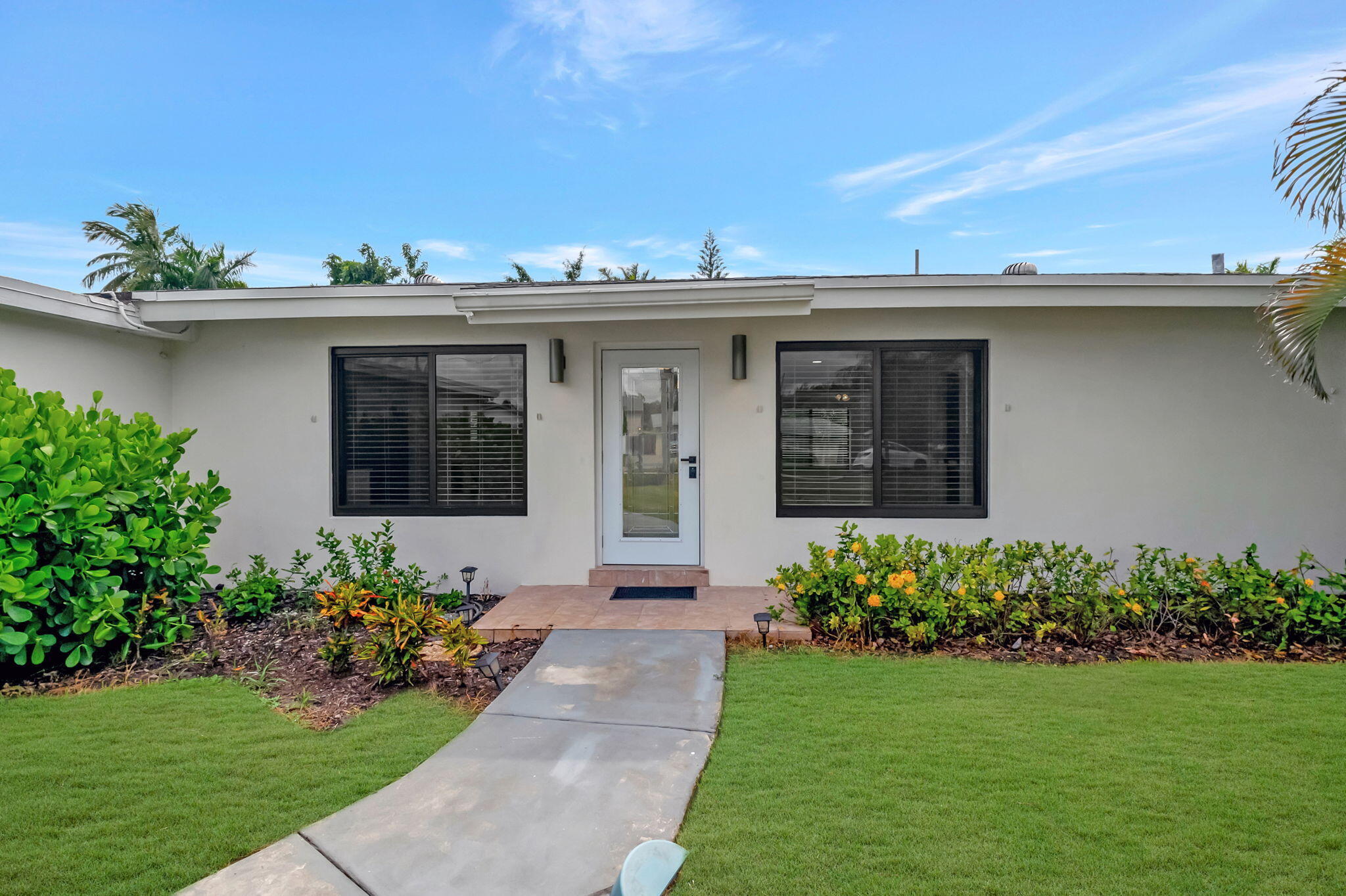 3550 Northeast 4th Avenue Boca Raton, FL 33431 - Photo 3 of 26 a front view of a house with a garden