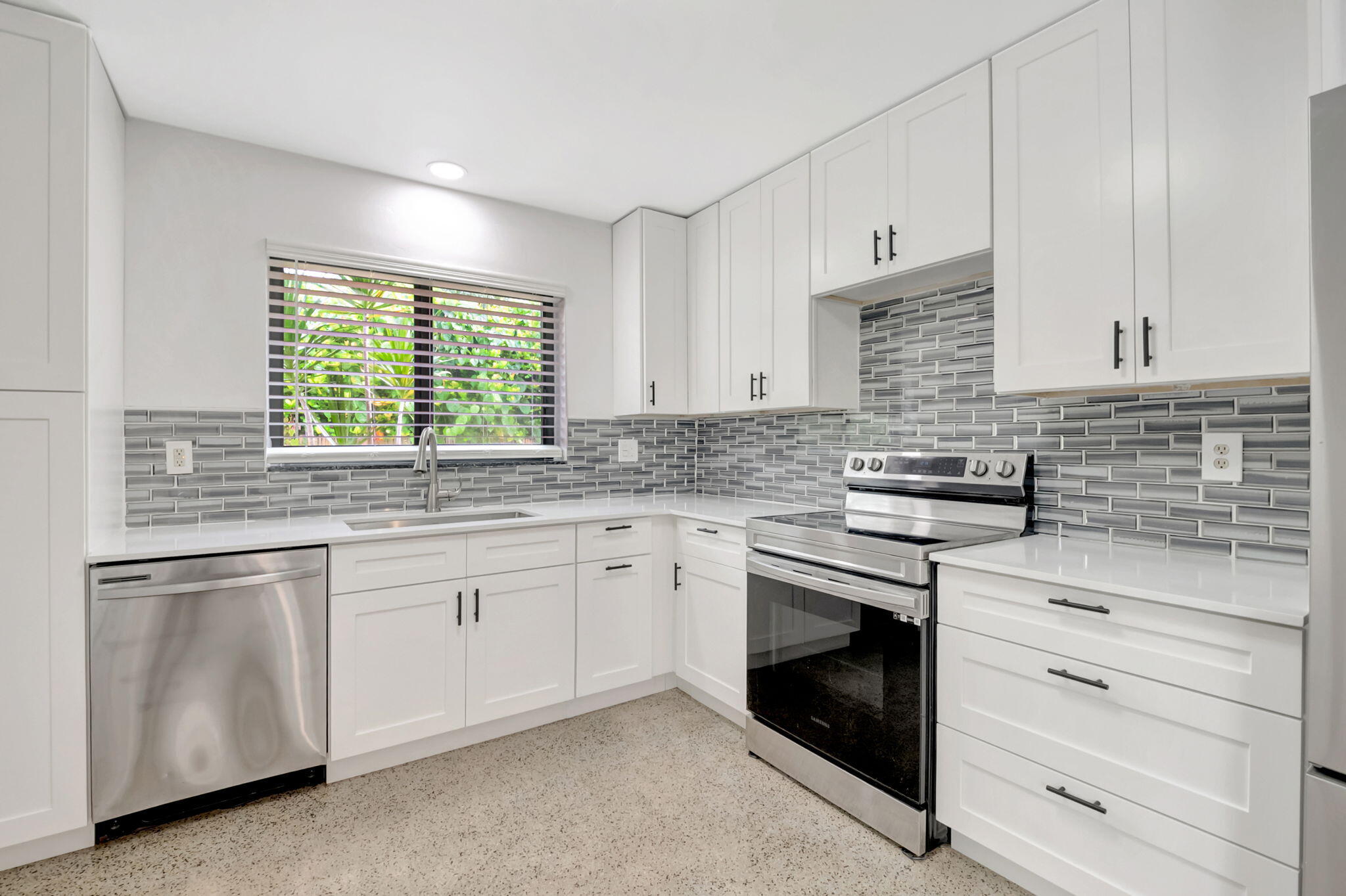 3550 Northeast 4th Avenue Boca Raton, FL 33431 - Photo 8 of 26 a kitchen with granite countertop white cabinets stainless steel appliances a sink and a window