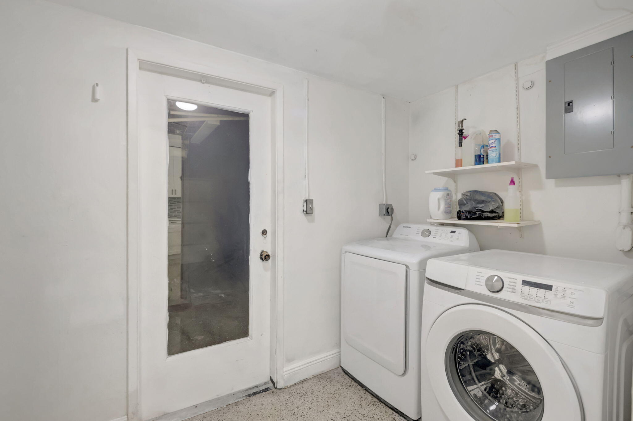 3550 Northeast 4th Avenue Boca Raton, FL 33431 - Photo 9 of 26 a view of washer and dryer with kitchen in the background