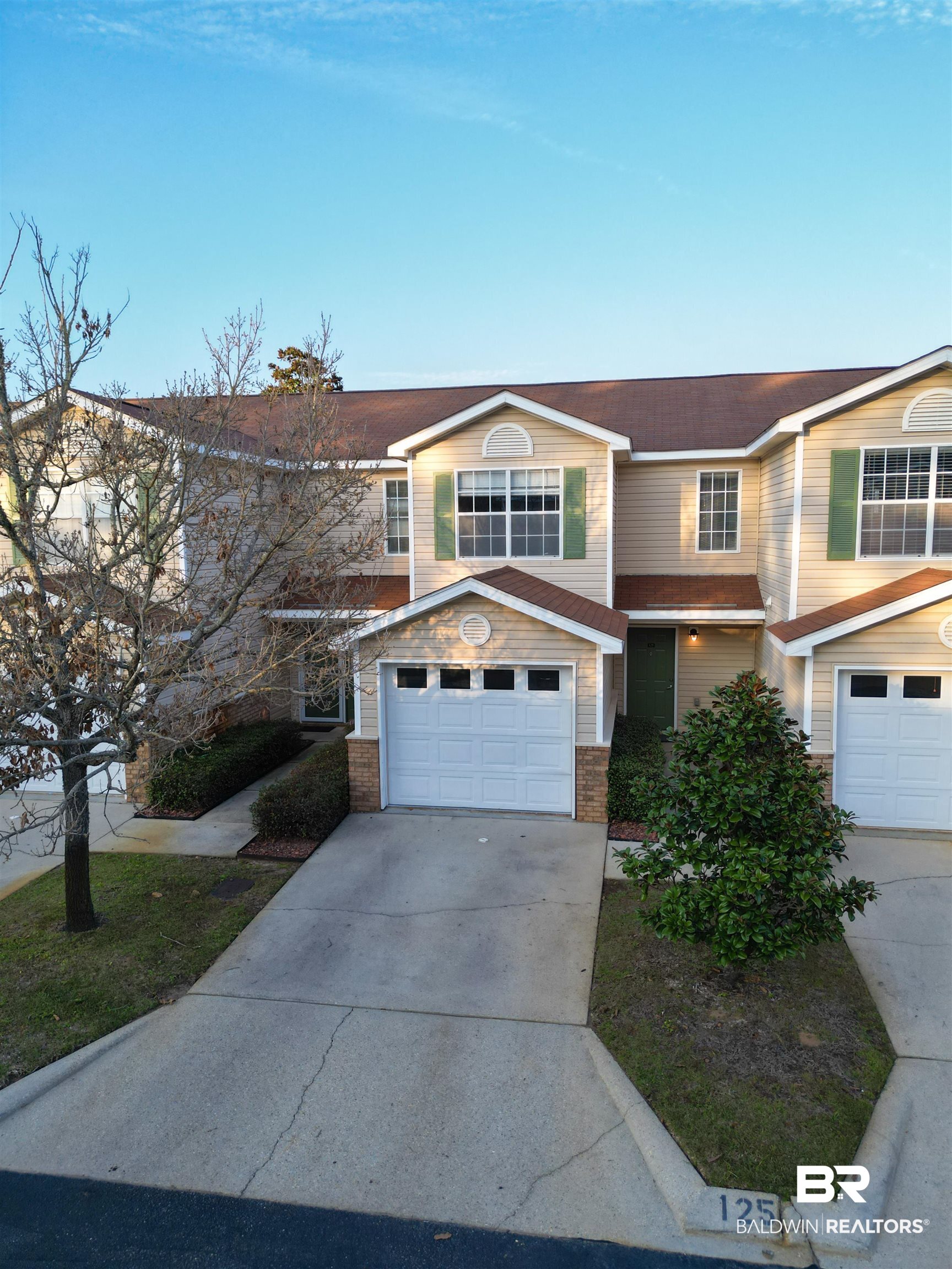 1517 Regency Road, Unit 125 Gulf Shores, AL 36542 - Photo 2 of 26 Traditional home with concrete driveway and a garage