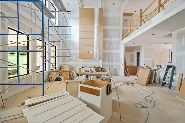 a large kitchen with stainless steel appliances kitchen island a large counter top a stove and a refrigerator