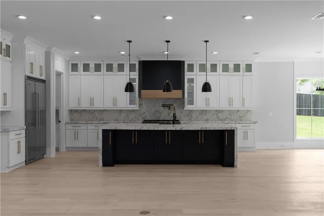 a kitchen with granite countertop white cabinets and a stove