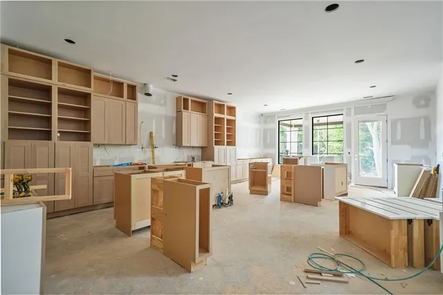 a kitchen with white cabinets and white appliances