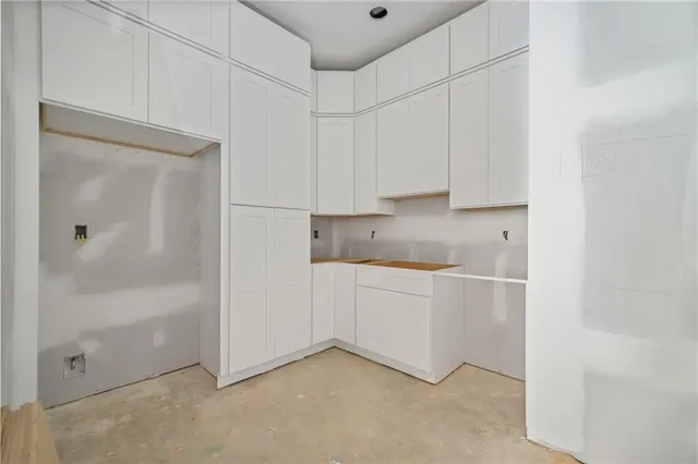 a view of an empty room with a fireplace and a window