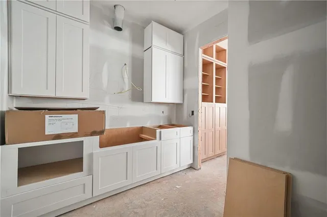 a spacious bedroom with a balcony furniture and a large window