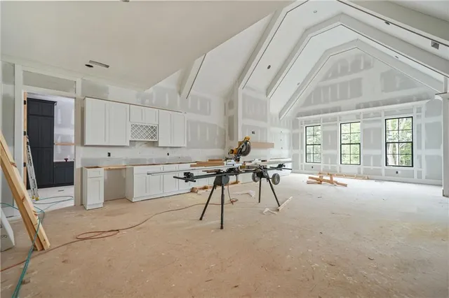 an empty room with windows and closet