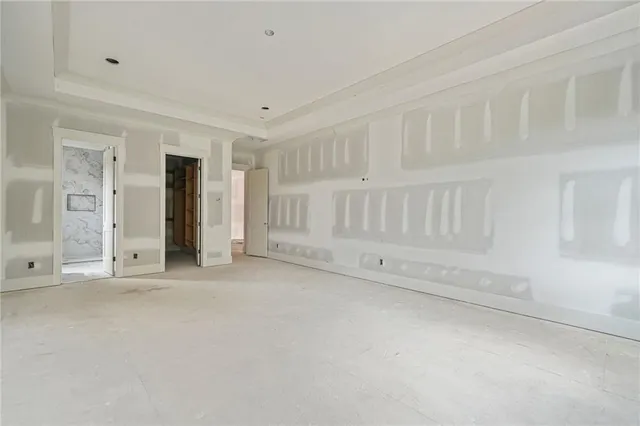 a view of a patio with a table and chairs and floor to ceiling window
