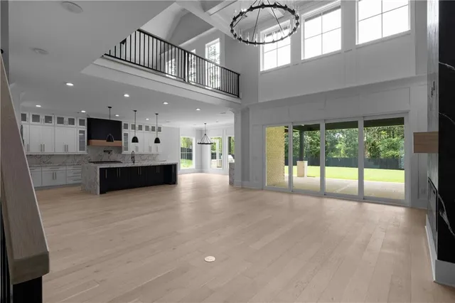 a living room with furniture and large windows