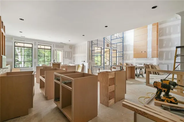 a large kitchen with stainless steel appliances granite countertop a stove and a granite counter tops