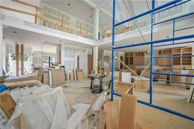 a living room with furniture a large window and kitchen view