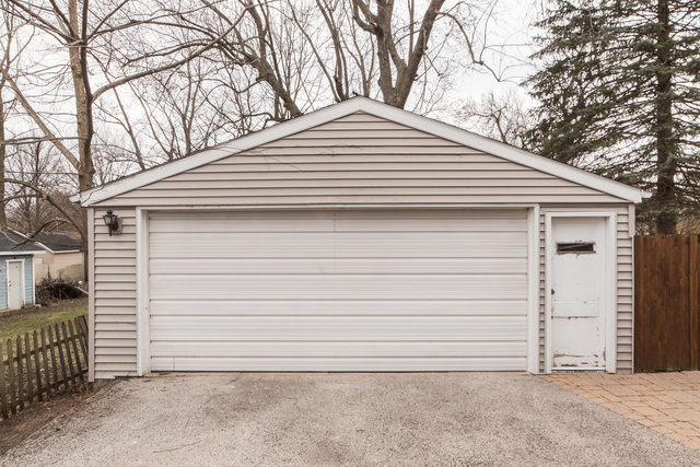 927 Townsend Street Sycamore, IL 60178 - Photo 18 of 18 a small white house with a white roof and wooden fence