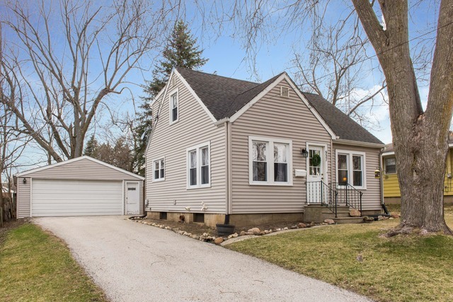 927 Townsend Street Sycamore, IL 60178 - Photo 2 of 18 a front view of a house with a yard and garage