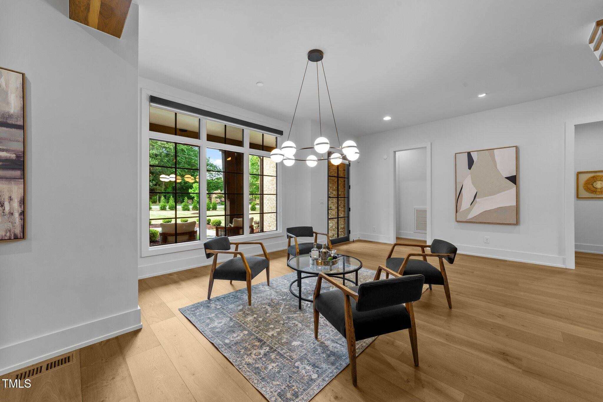 15517 Possum Track Road Raleigh, NC 27614 - Photo 20 of 66 a living room with furniture and a chandelier