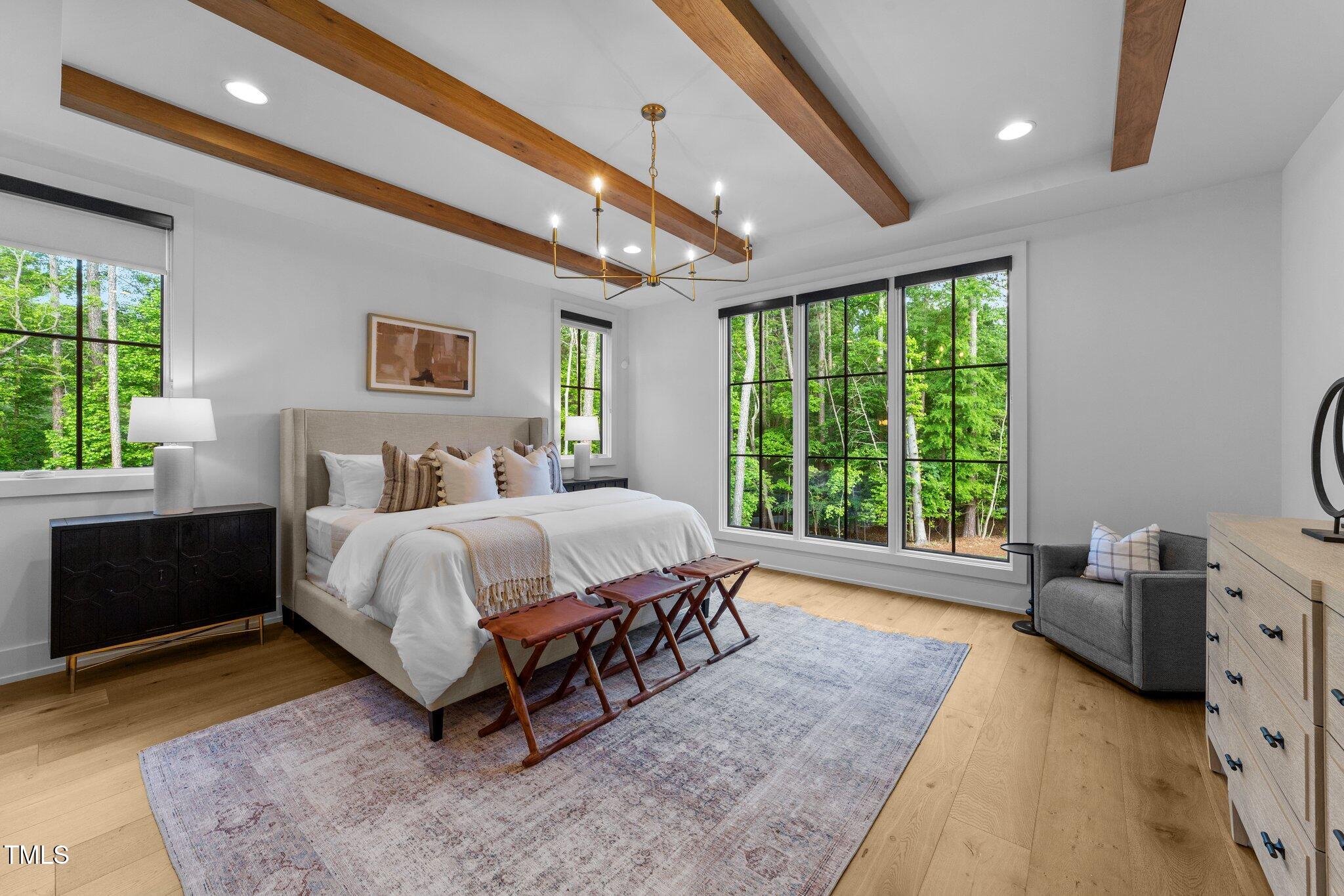 15517 Possum Track Road Raleigh, NC 27614 - Photo 28 of 66 a spacious bedroom with a bed and a couch