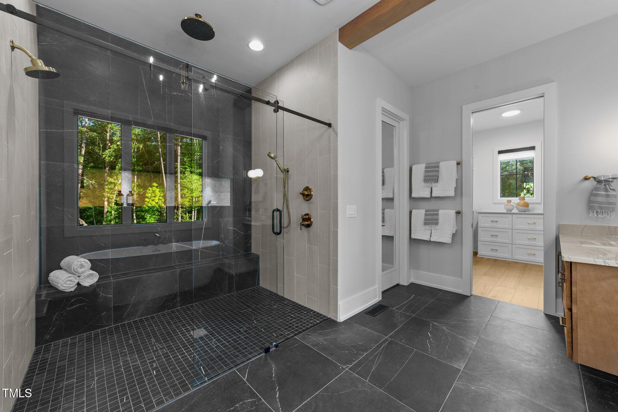 15517 Possum Track Road Raleigh, NC 27614 - Photo 32 of 66 a bathroom with a glass shower door