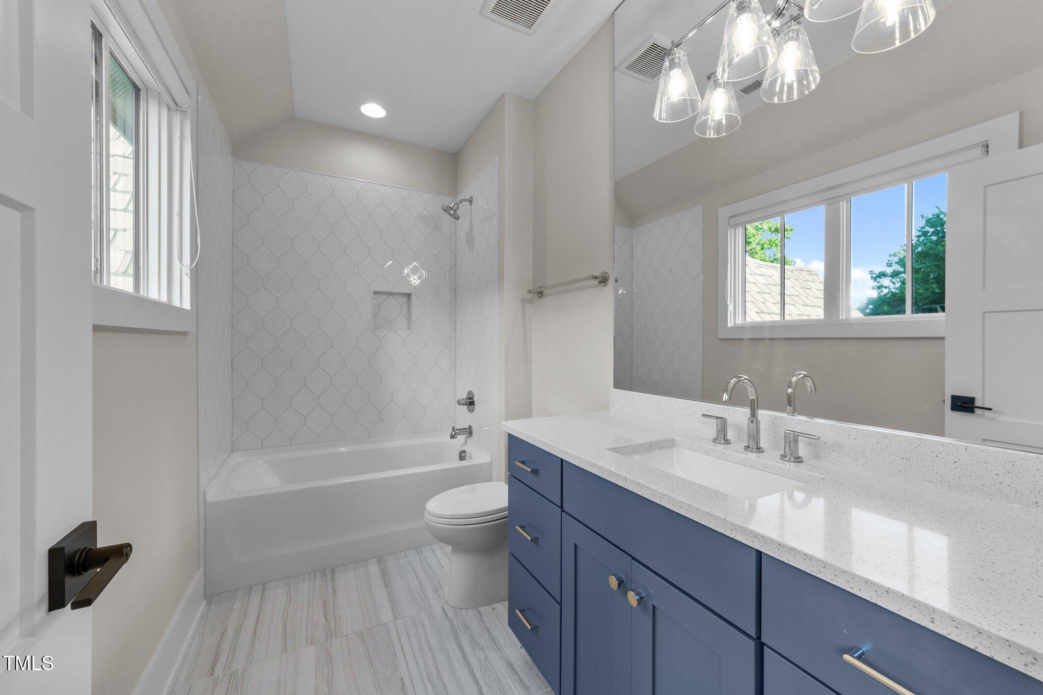 15517 Possum Track Road Raleigh, NC 27614 - Photo 42 of 66 a bathroom with a tub a sink and a large mirror