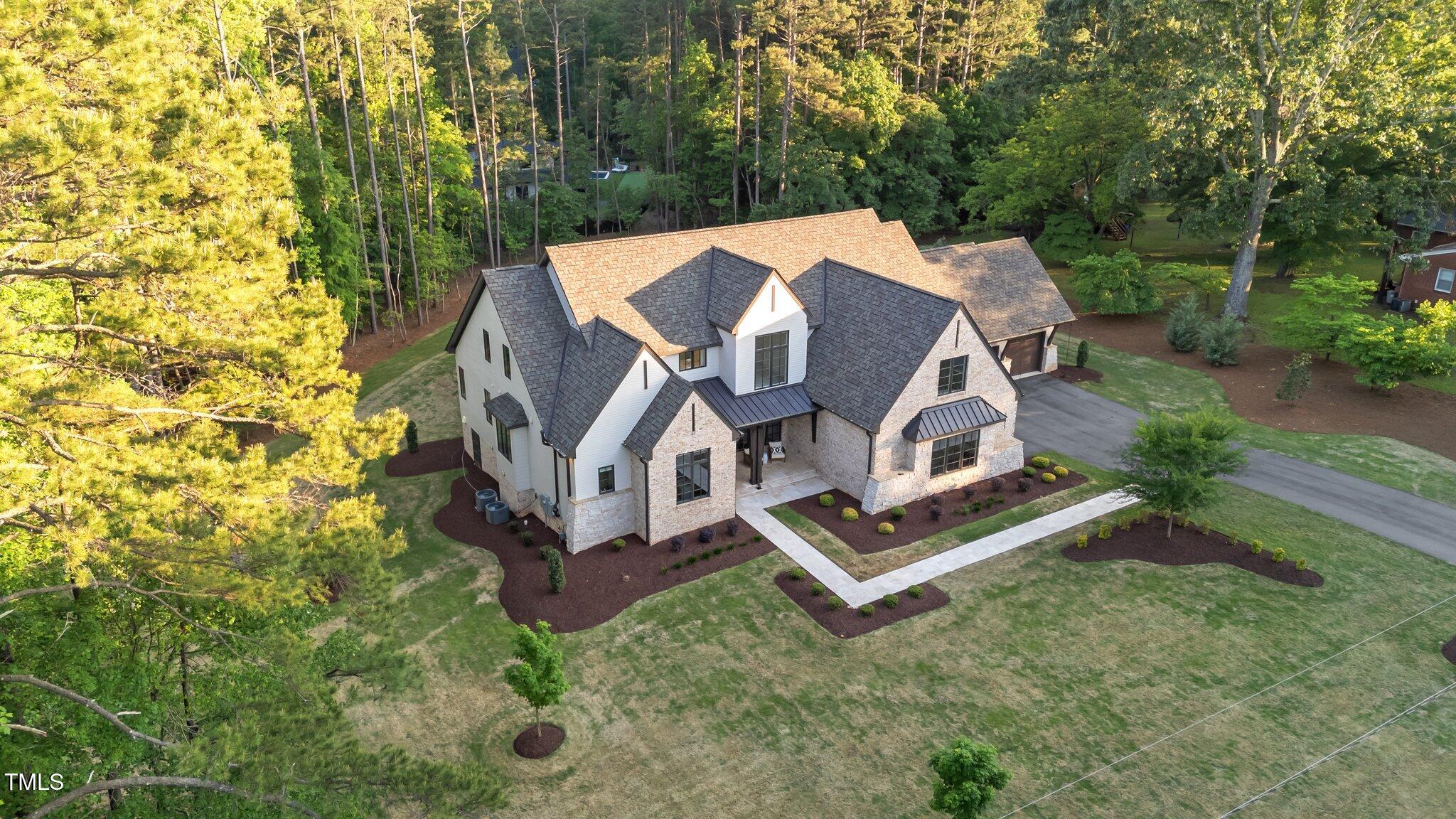15517 Possum Track Road Raleigh, NC 27614 - Photo 59 of 66 an aerial view of a house with swimming pool and large trees