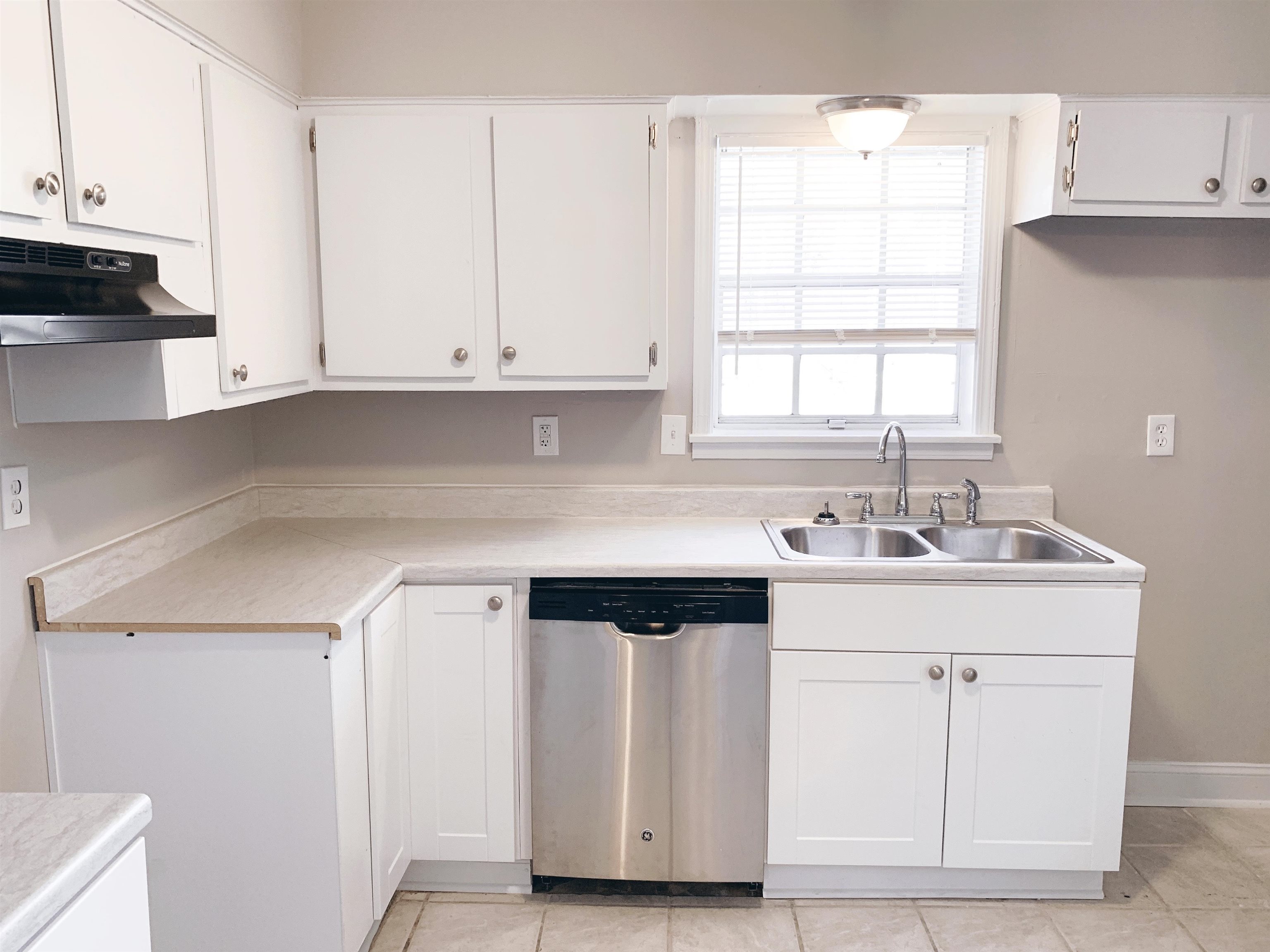 1084 Rutland Road Memphis, TN 38114 - Photo 11 of 13 a kitchen with white cabinets and sink
