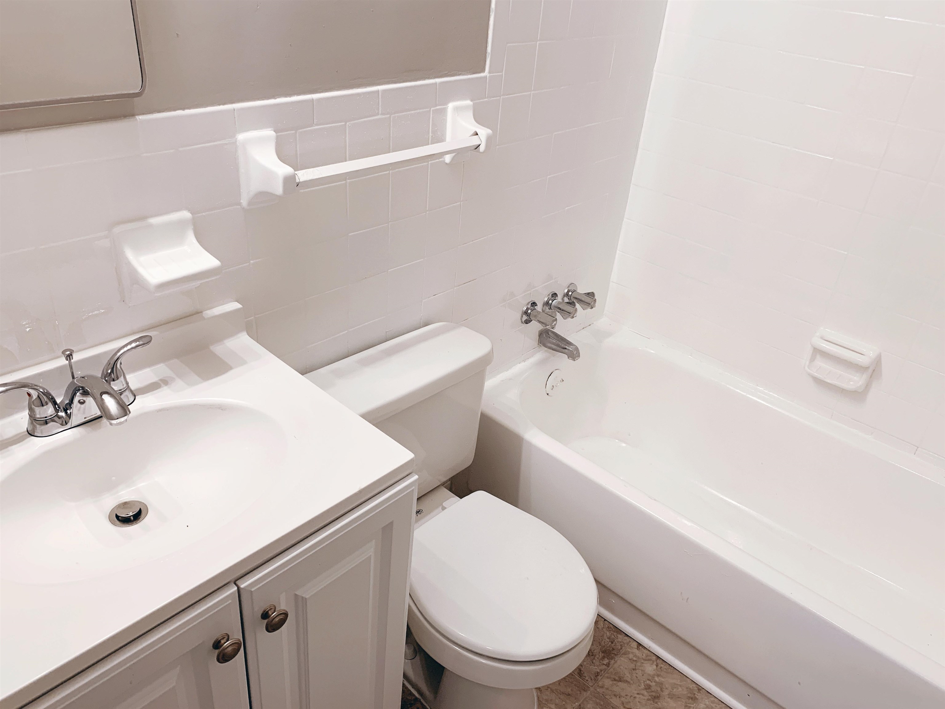 1084 Rutland Road Memphis, TN 38114 - Photo 4 of 13 a white toilet sitting next to a bathroom sink