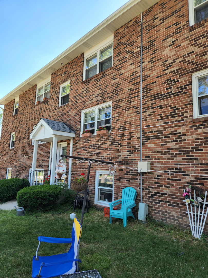 1235 Columbia Street, Unit 5 Crete, IL 60417 - Photo 13 of 13 a front view of a house with garden and porch