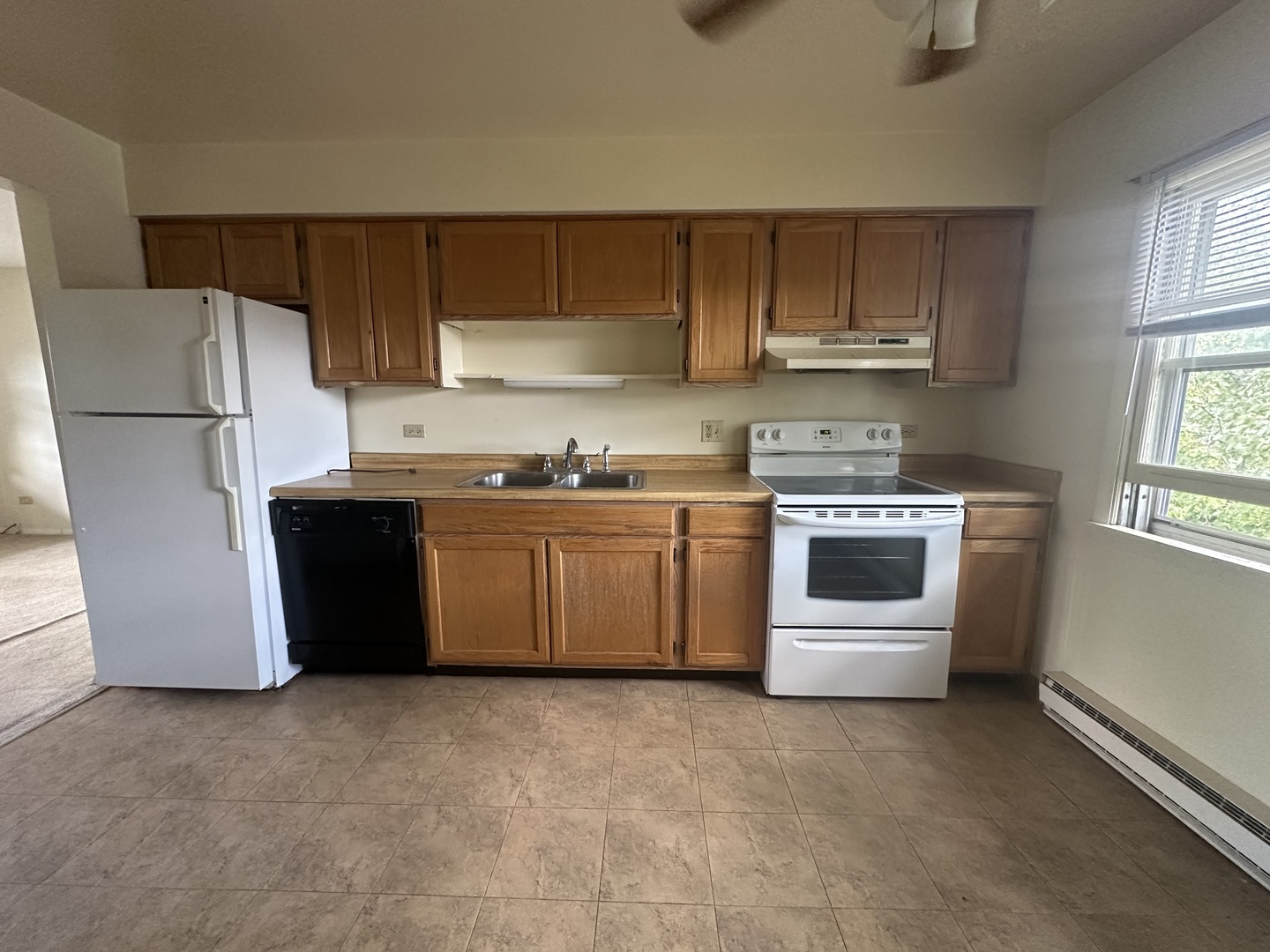 1235 Columbia Street, Unit 5 Crete, IL 60417 - Photo 2 of 13 a kitchen with stainless steel appliances a stove a sink and a refrigerator