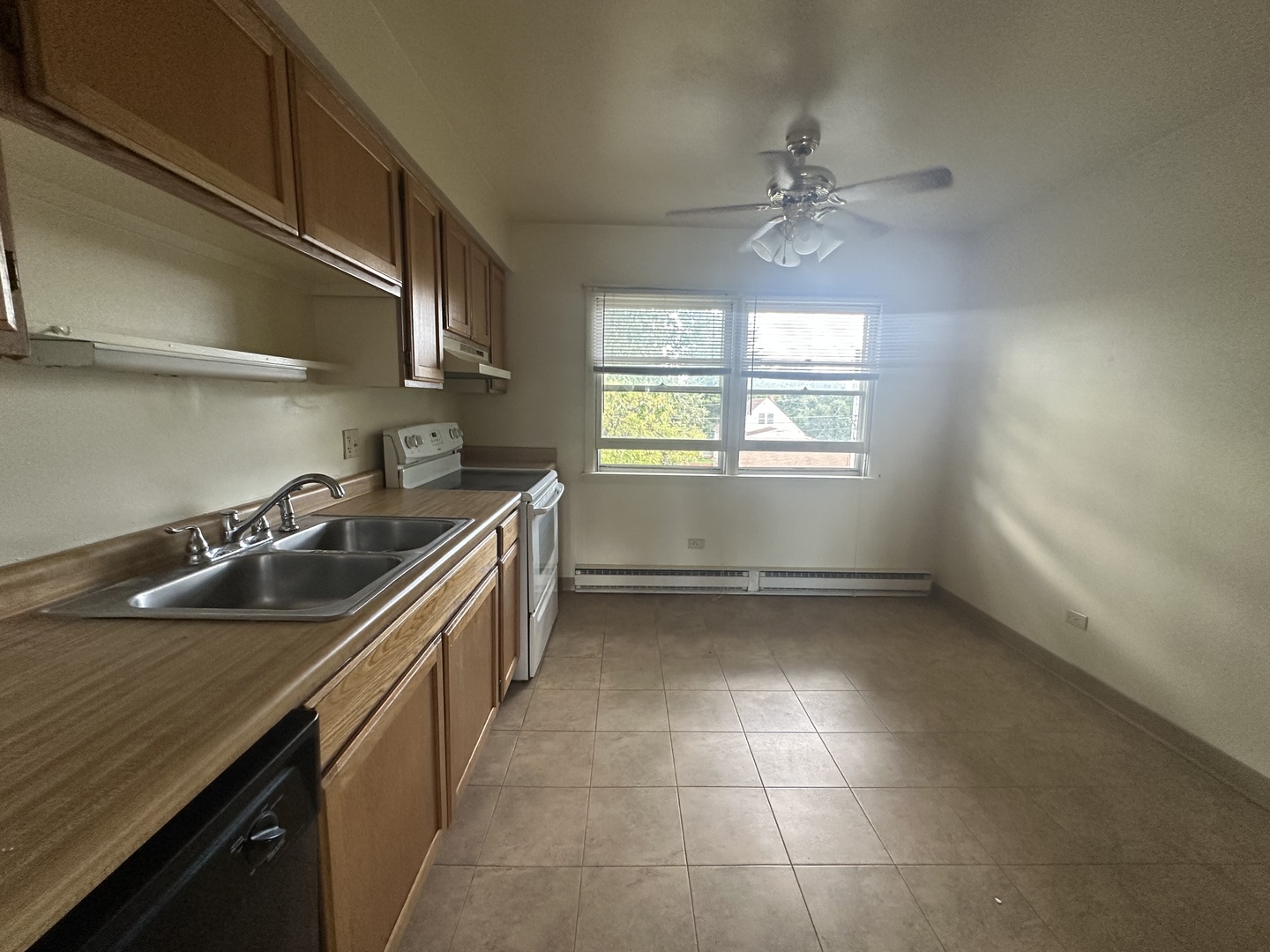 1235 Columbia Street, Unit 5 Crete, IL 60417 - Photo 3 of 13 a kitchen that has a sink and a stove