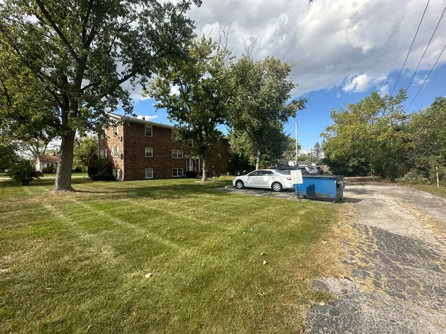 a house view with swimming pool and trees in the background