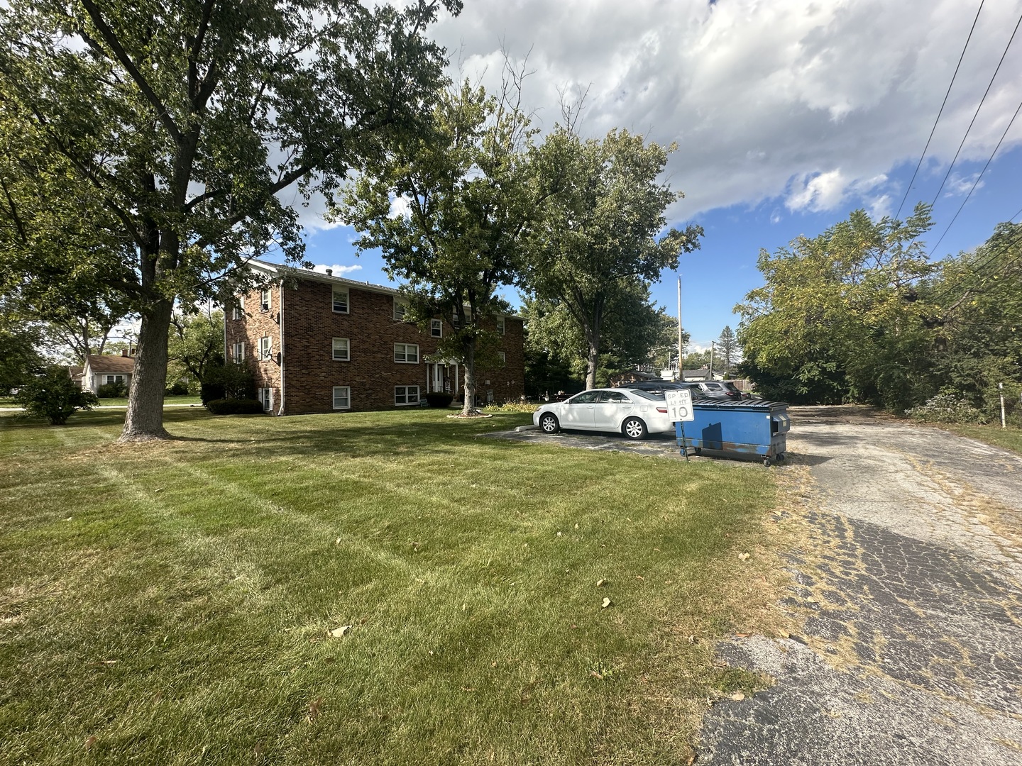 1235 Columbia Street, Unit 5 Crete, IL 60417 - Photo 10 of 13 a house view with swimming pool and trees in the background