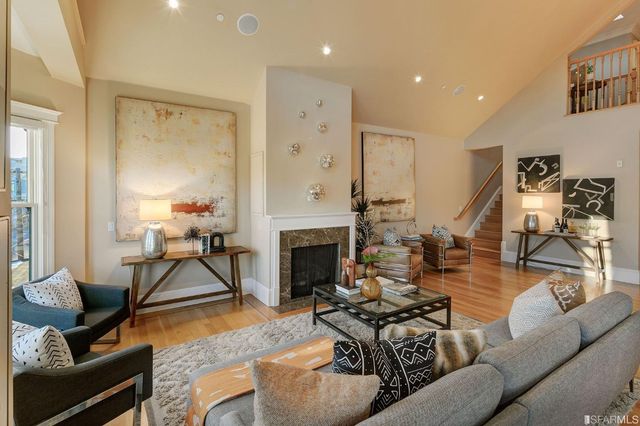 a living room with furniture large window and a fireplace