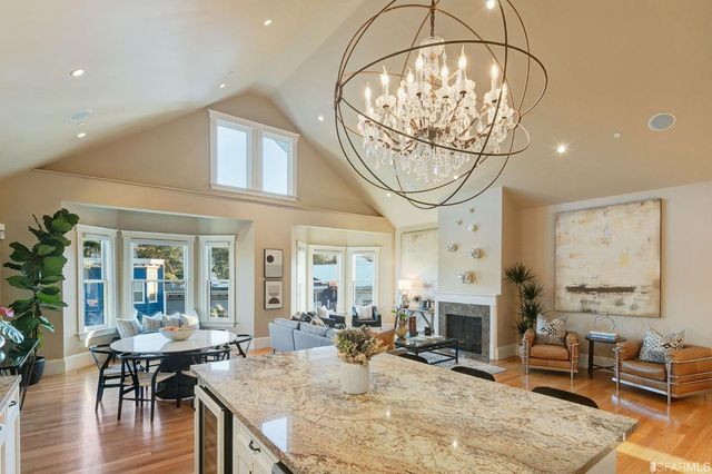 a kitchen with granite countertop a sink a counter top space and living room view