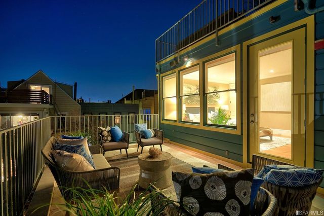 a bedroom with a large bed and a potted plant