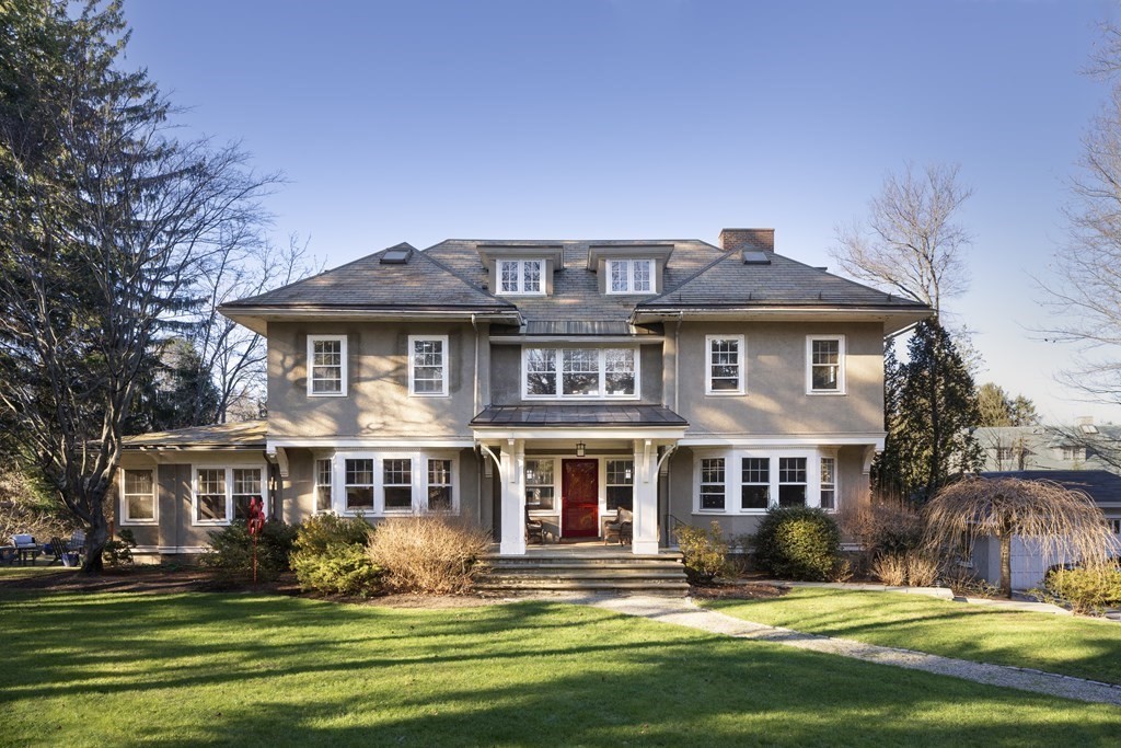 a front view of a house with a yard table and chairs