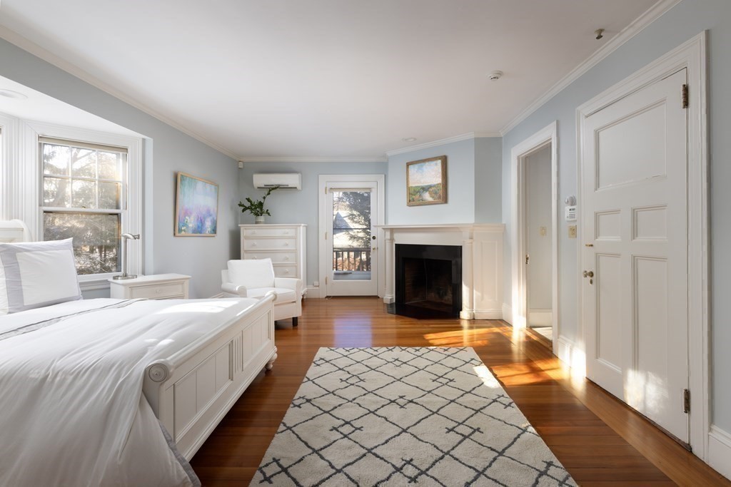 96 Crafts Road Brookline, MA 02467 - Photo 18 of 30 a spacious bedroom with a bed and a fireplace