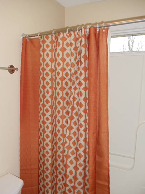 1624 Meadows Road Vinton, VA 24179 - Photo 13 of 30 a bathroom with a shower curtain and a toilet next to a window