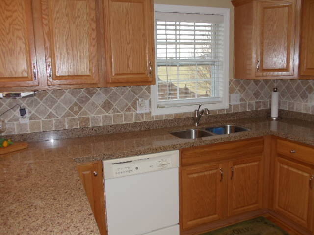 1624 Meadows Road Vinton, VA 24179 - Photo 8 of 30 a kitchen with a sink window and cabinets