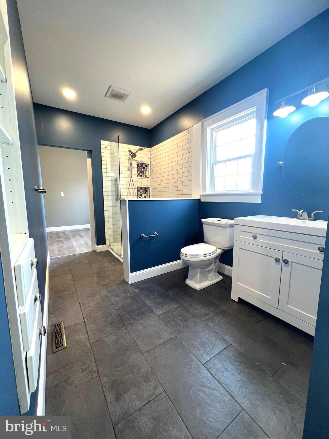 7617 Old Plank Road Fredericksburg, VA 22407 - Photo 26 of 61 a bathroom with a toilet sink and mirror