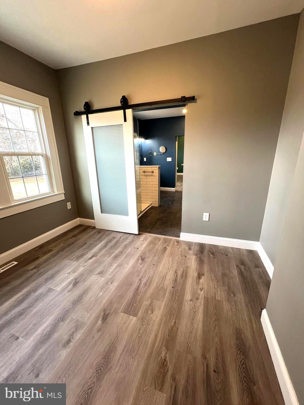 7617 Old Plank Road Fredericksburg, VA 22407 - Photo 28 of 61 an empty room with wooden floor and windows