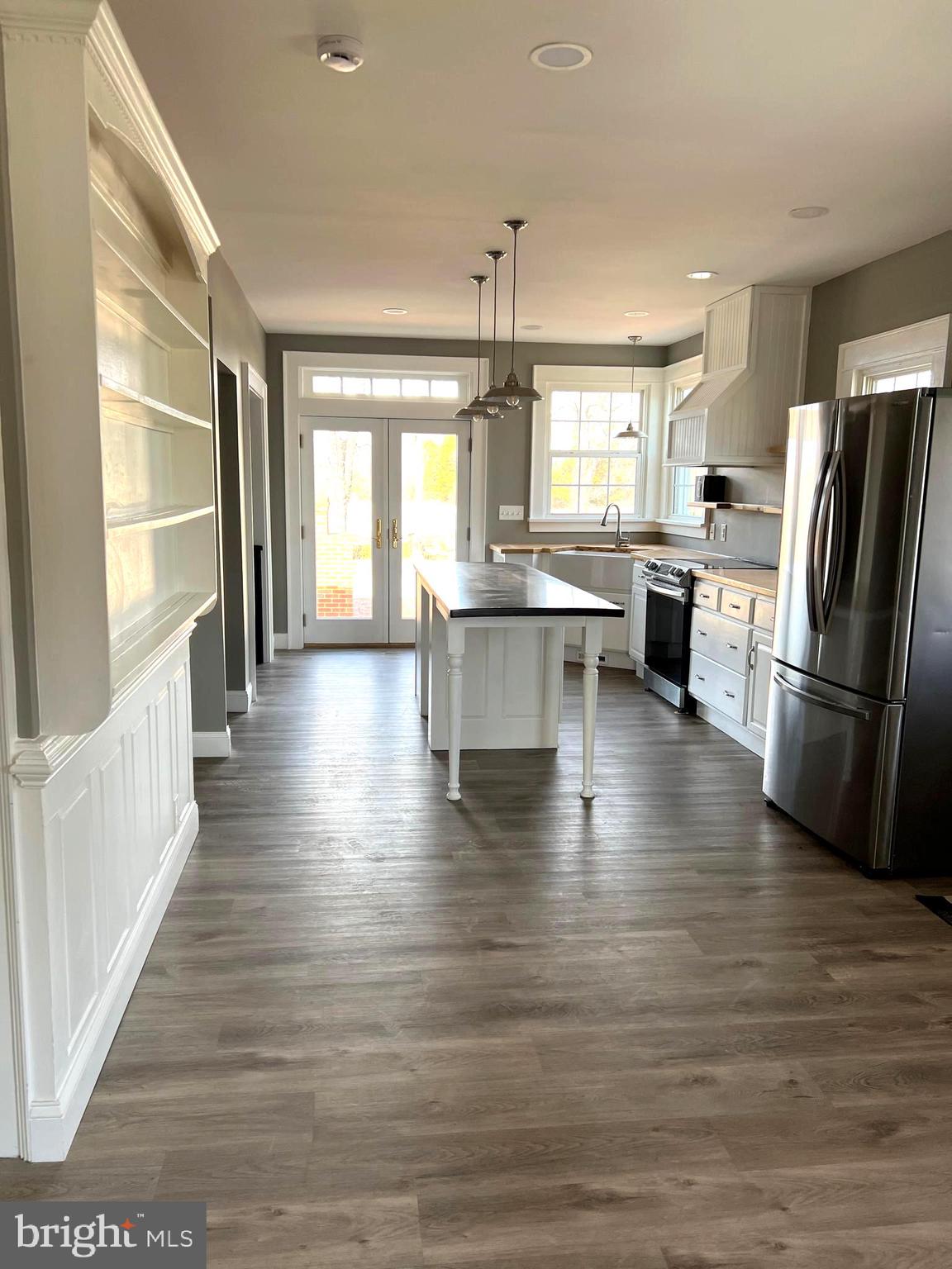 7617 Old Plank Road Fredericksburg, VA 22407 - Photo 53 of 61 a kitchen with stainless steel appliances a refrigerator a sink dishwasher a stove and white cabinets with wooden floor